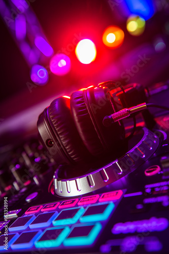 Dj mixer with headphones at a nightclub