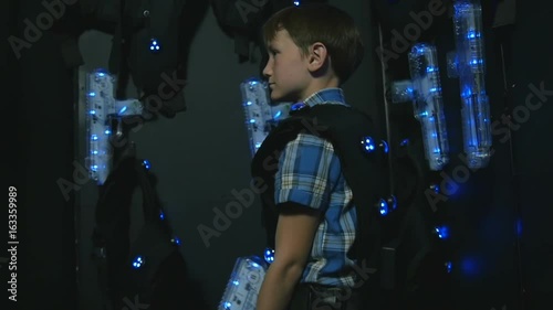 Boy takes aim at a lasertag weapon