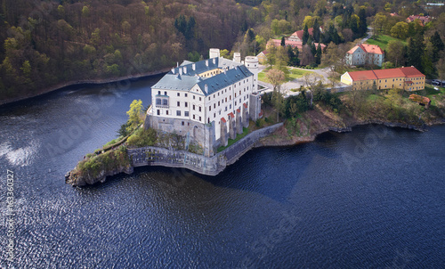 Aerial view on czech romantic, gothic chateâu Orlik, situated on rock outcrop above  Orlik reservoir in beautiful spring nature.Romantic, royal Schwarzenberg castle above water level. Czech landscape.