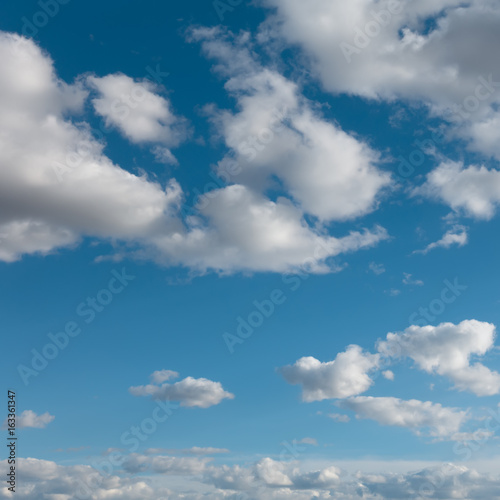 Beautiful light blue sky and clouds. Clouds flying over horizon  cloudscape.