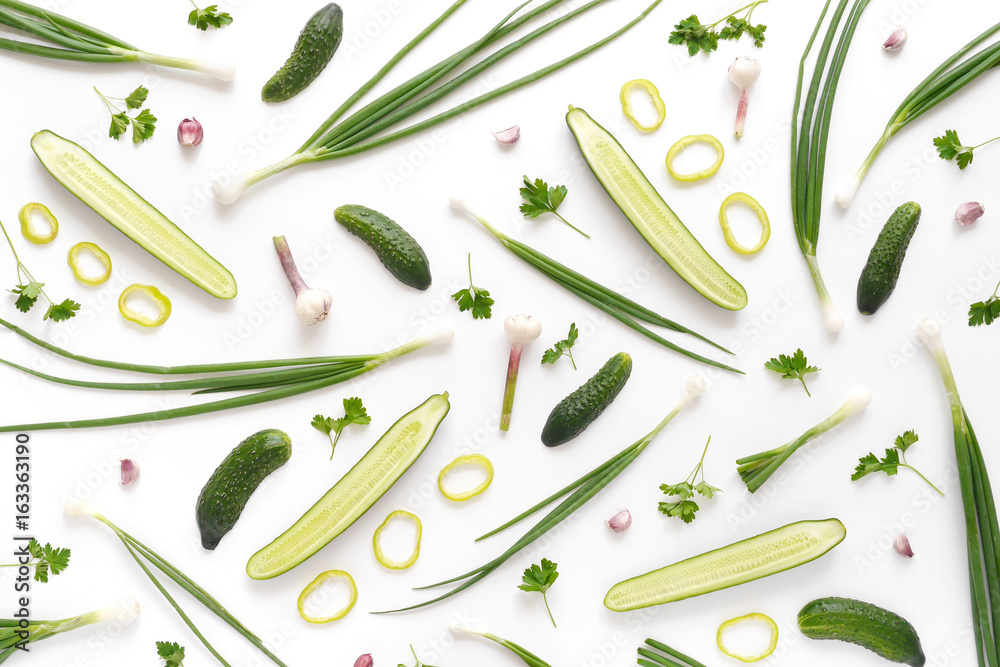 Abstract composition of vegetables. Vegetable pattern. Food background. Top  view. Large and small cucumbers, garlic, tomatoes and green onions on a  white background. Food concept. Sliced vegetables. Stock Photo | Adobe Stock