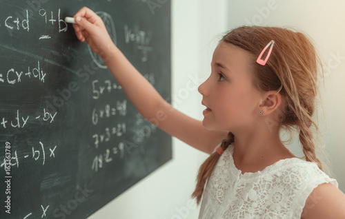 child solving math problems photo