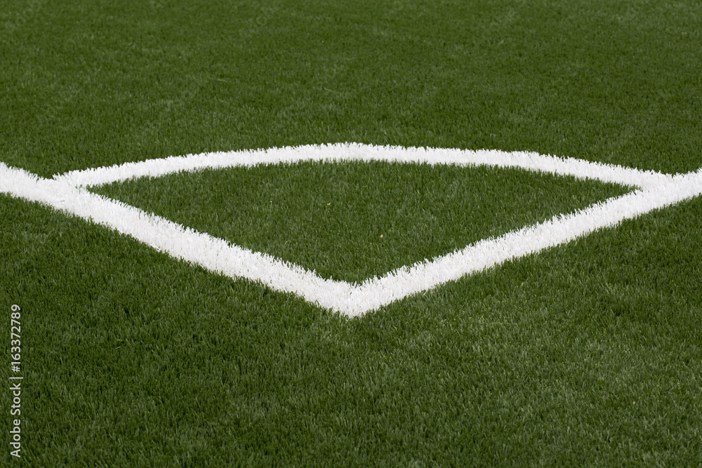 A closeup photo taken on a football field line paint marking.