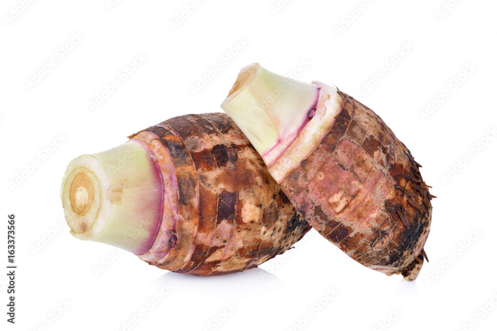whole and half cut unpeeled raw taro on white background