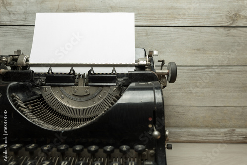 Old typewriter with blank sheet of paper