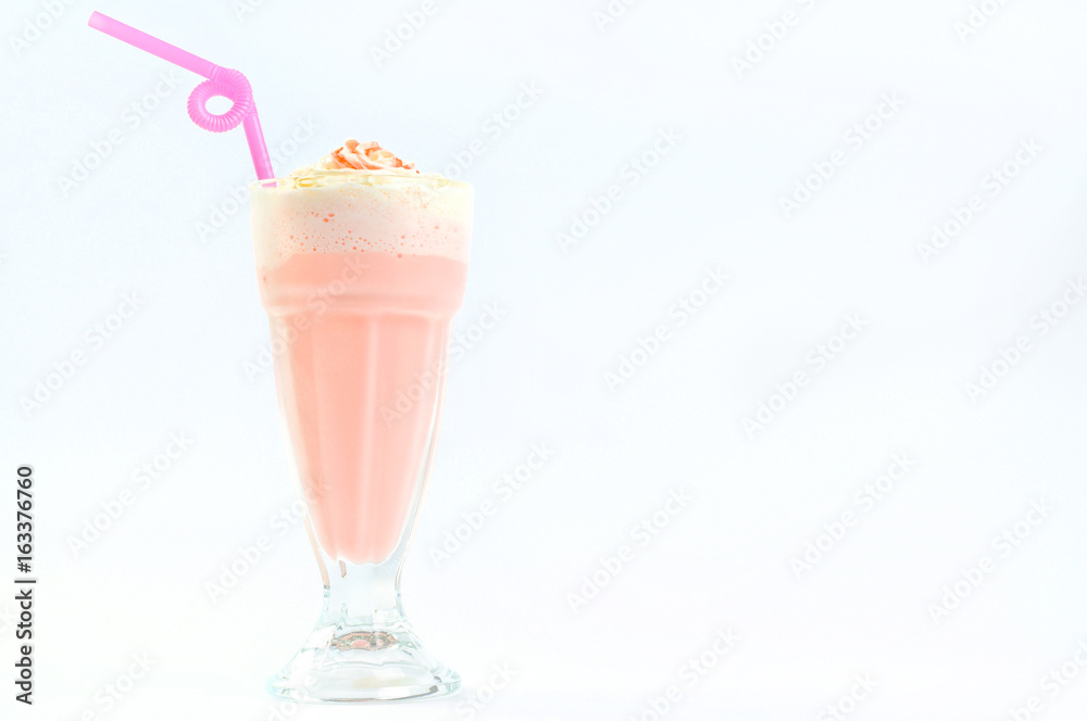 Pink milkshake in high glass with a straw. Pink milkshake in high glass with a straw.