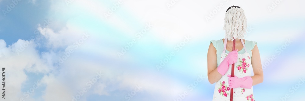 Cleaner hiding behind mop with bright background Cleaner hiding behind mop with bright background