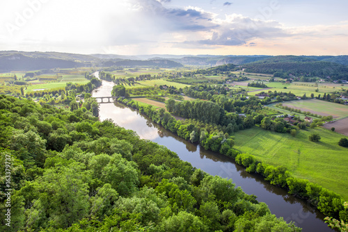 Aerial landscape view on Dordogne river with the old bridge and beautiful fields near Domme village in France