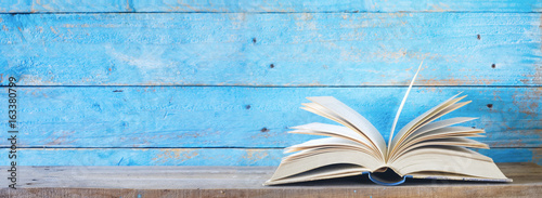 open book on blue grungy background, good copy space
