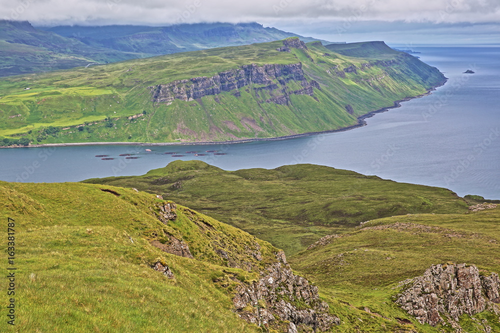 Fototapeta premium View from the mountain Ben Tianavaig towards the Trotternish peninsula and with the Old Man of Storr in the background, Isle of Skye, Highlands, Scotland, UK