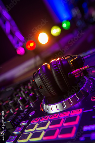 Dj mixer with headphones at a nightclub