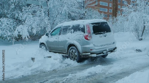 Car wheels riding on deep snow at winter season