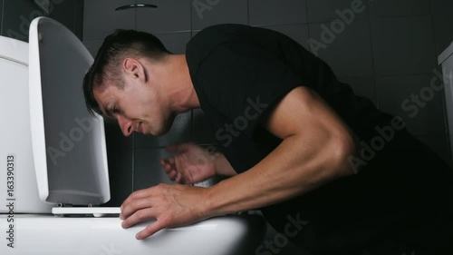 Throwing up in bathroom toilet photo