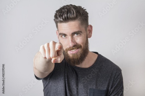 Young man pointing with finger.