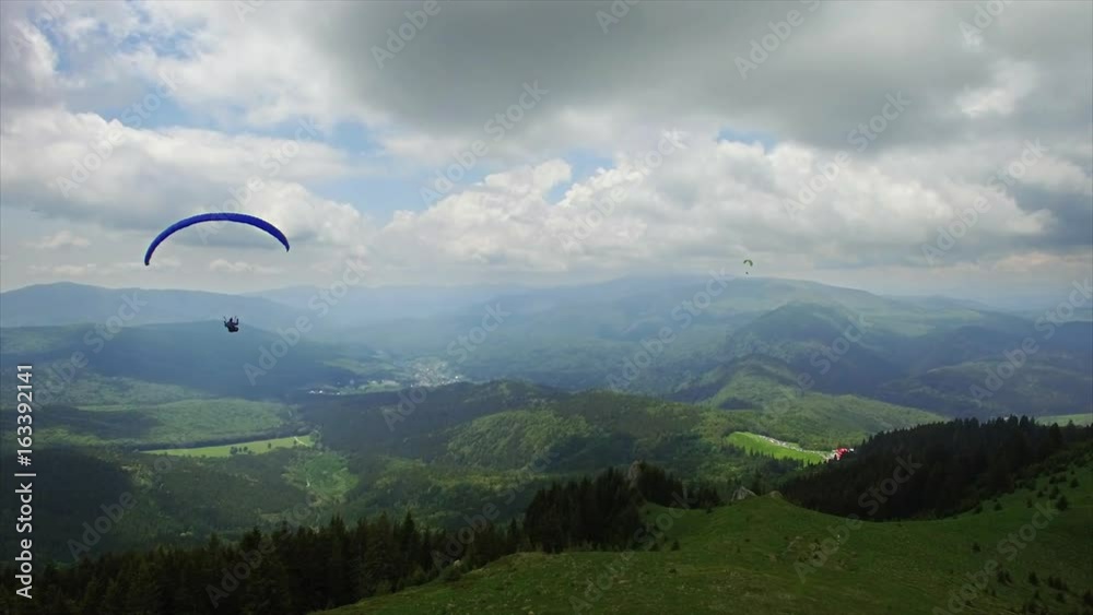 Aerial Paragliding over Mountains and Valleys Aerial Paragliding over Mountains and Valleys