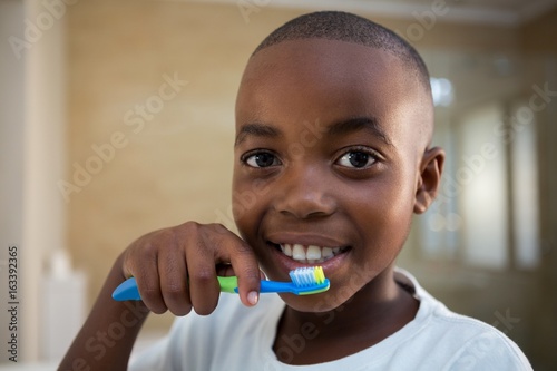 Close-up portrait of boy with toothbrush
