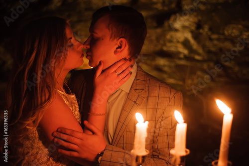 Romantic dinner of a young couple by candlelight in the mountains