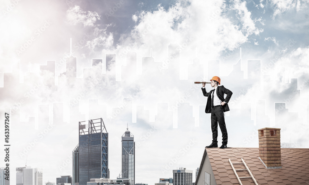 Engineer man standing on roof and looking in spyglass. Mixed med Engineer man standing on roof and looking in spyglass. Mixed med