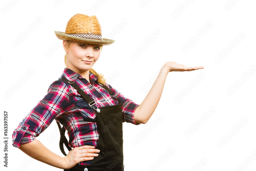 Woman wearing sun hat, showing copyspace on hand Woman wearing sun hat, showing copyspace on hand