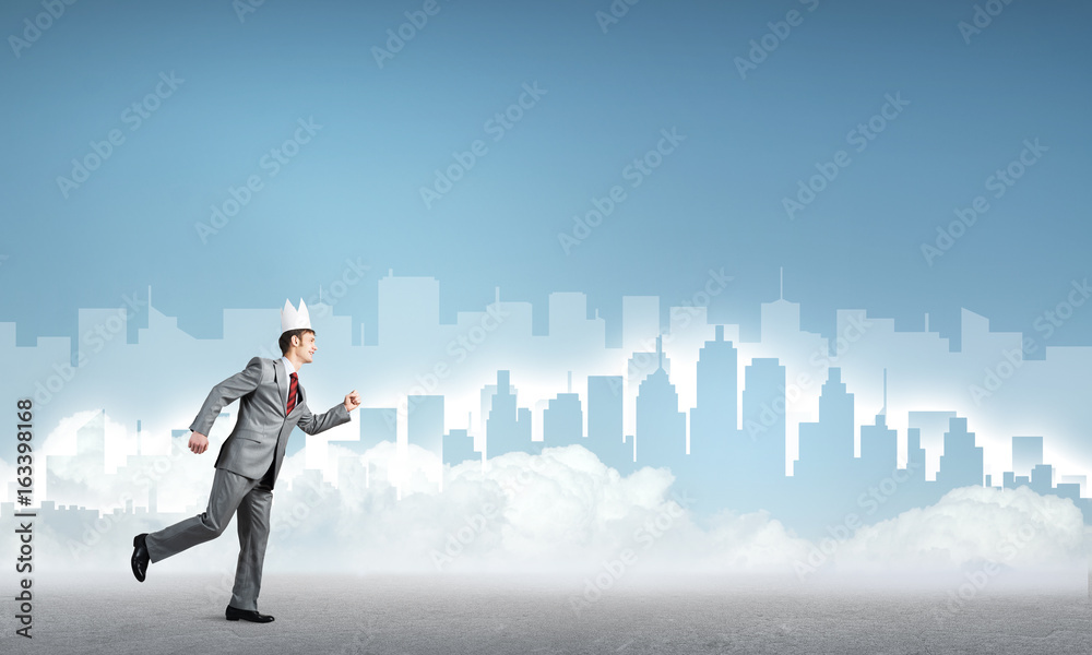 King businessman in elegant suit running and blue cityscape silhouette at background King businessman in elegant suit running and blue cityscape silhouette at background