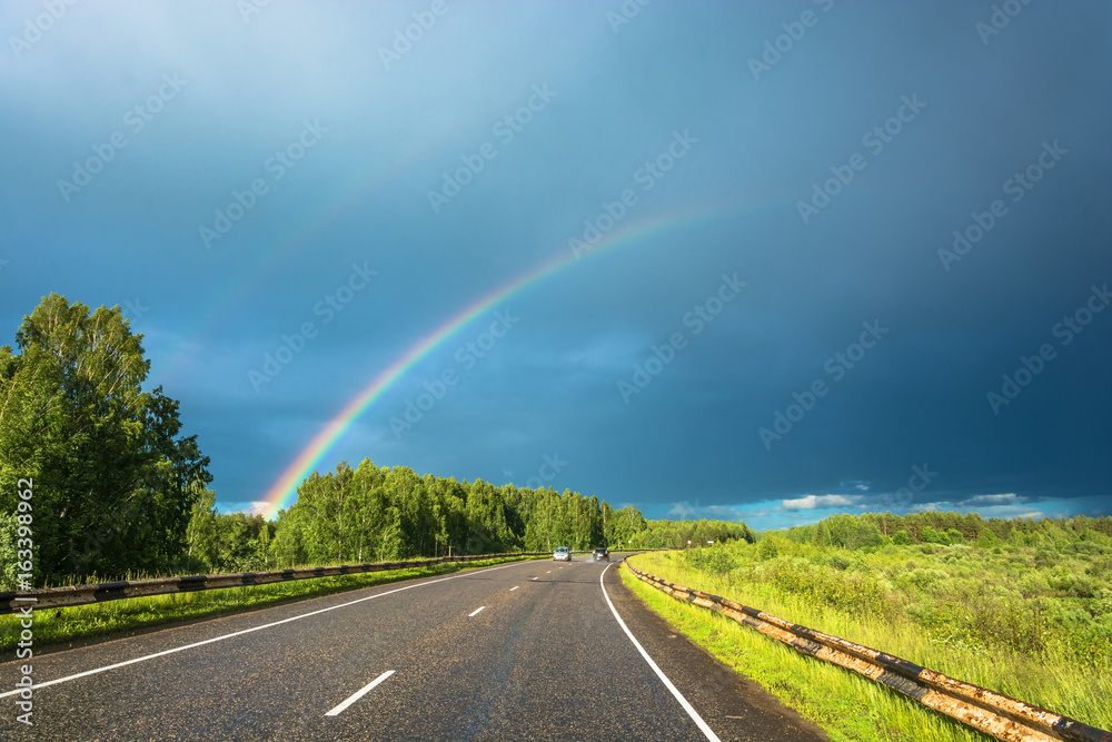 Colorful rainbow over the highway.