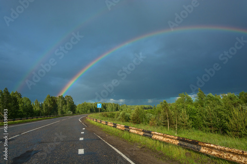 Colorful rainbow over the highway.