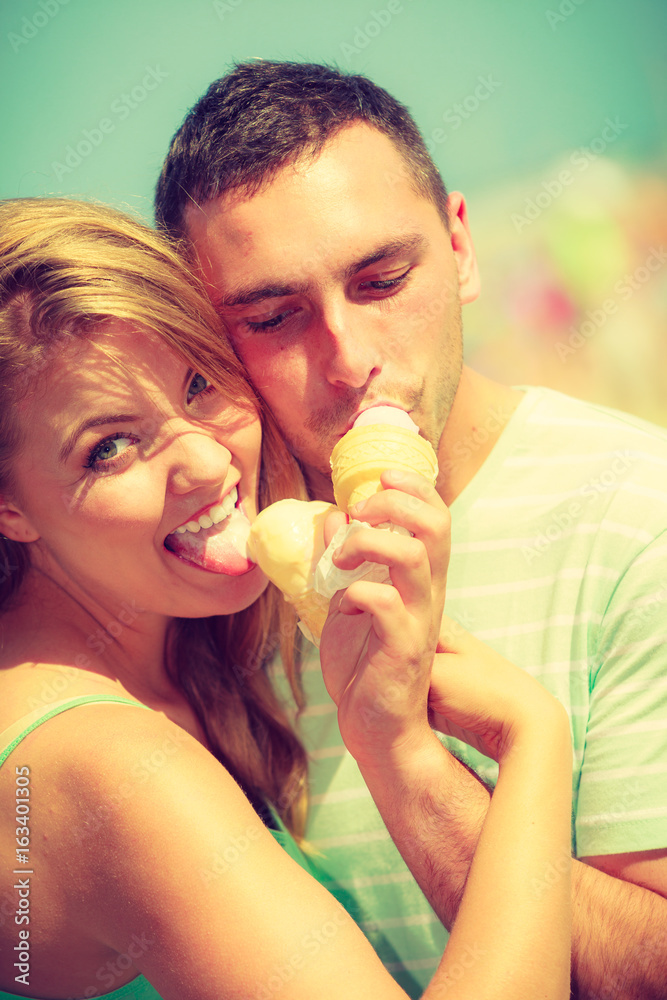 Man and woman eating ice cream on beach Man and woman eating ice cream on beach