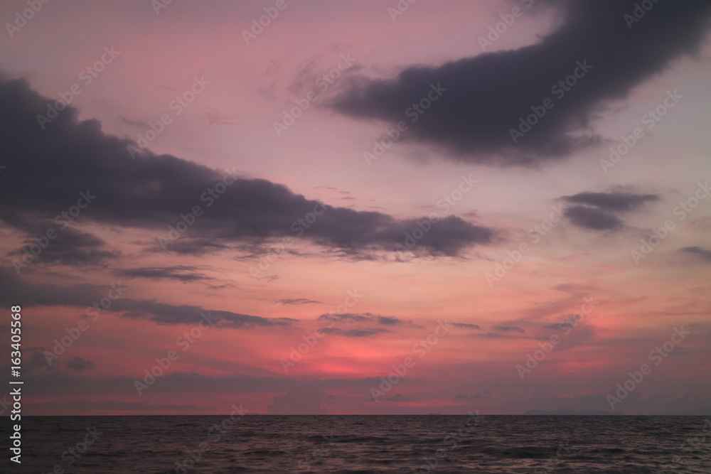 Incredible Purple and Pink Sunset Afterglow on Cloudy Sky over the Placid Sea in Thailand 