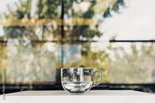 Fotografie Cup of water. Beautiful reflection of tree