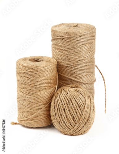 Burlap jute twine coil bobbins isolated on white