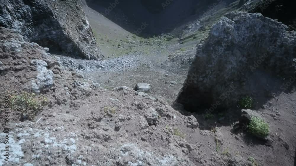 Person looking down from cliff edge and making steps back forth, vision doubling