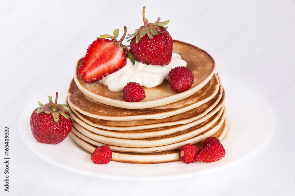 pancakes with strawberry on a white background in cream
