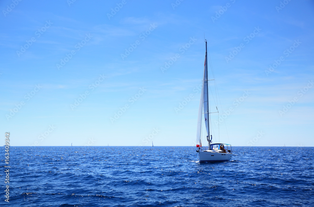 Sea horizon and small yacht