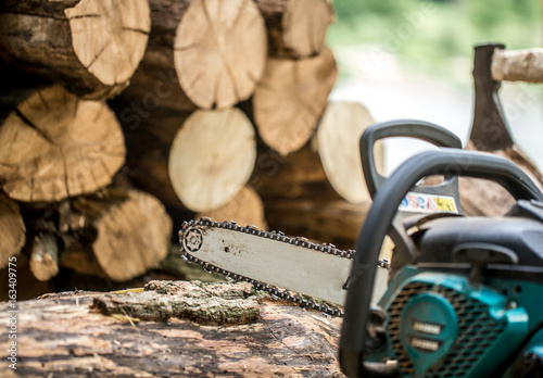 Man chopping wood with a chainsaw photo