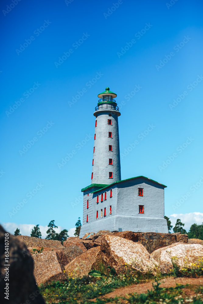 the layout of the Lighthouse on sand dune against blue sky with white clouds