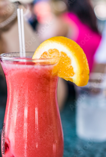 Macro closeup of iced strawberry daquiri in glass on table photo