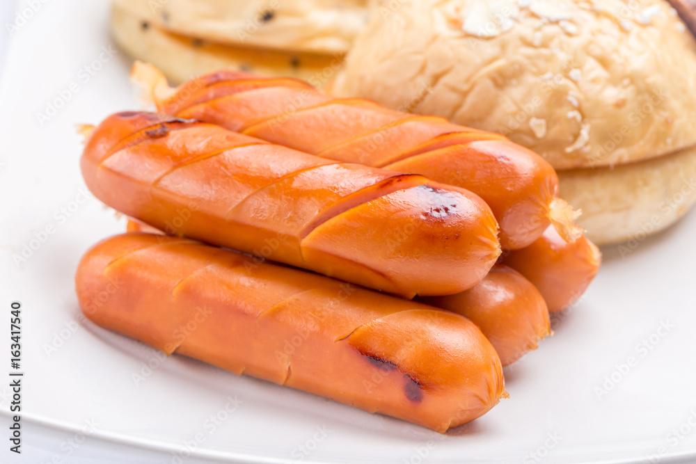 Grilled sausages stack served with the fresh oven breads, healthy breakfast in the morning. Grilled sausages stack served with the fresh oven breads, healthy breakfast in the morning.