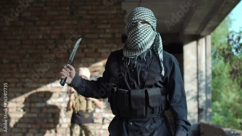 Terrorist looking at camera and talking while delivering video message.