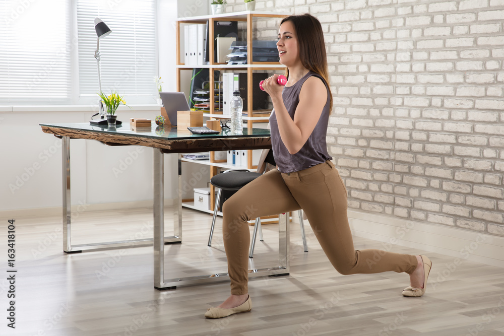 Businesswoman Doing Exercise With Dumbbells Businesswoman Doing Exercise With Dumbbells