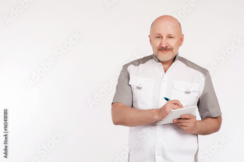 man writes in a notebook. T...