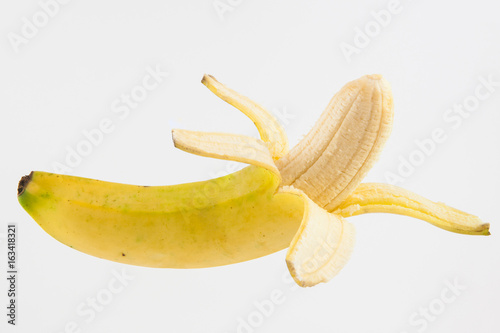 Half peeled banana (Musa acuminata) isolated on white background