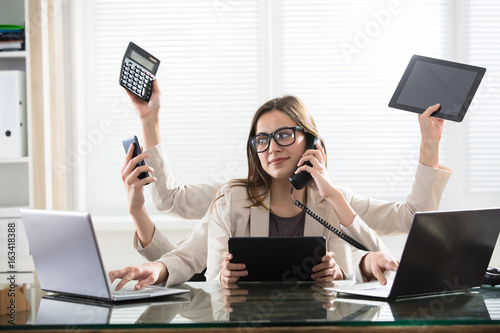 Multitasking Businesswoman In Office photo
