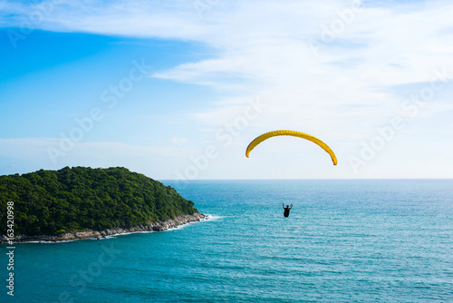 Paragliding flying over mountains in Phuket Thailand.