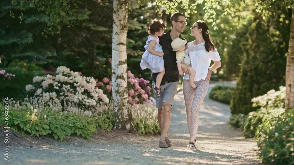 Happy family members having good time in a park, Red Epic light slow motion 4k 