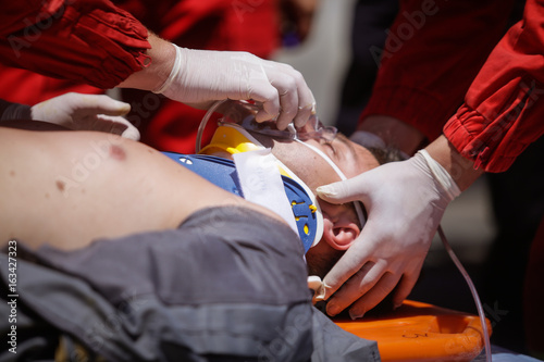 Paramedics rescue the victim of a drill car crash photo