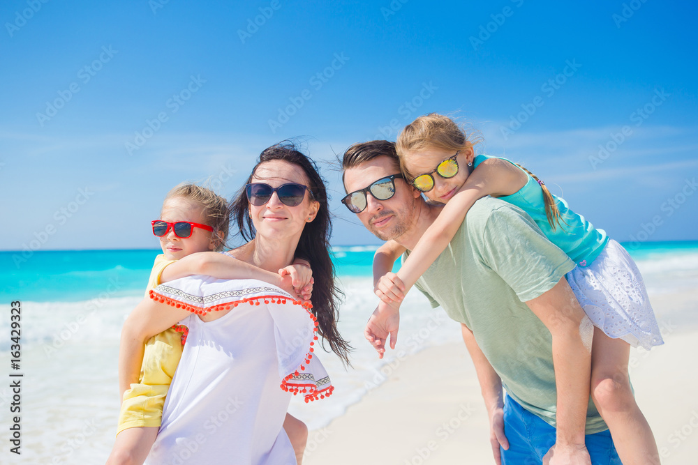 Portrait of happy family on a tropical beach Portrait of happy family on a tropical beach