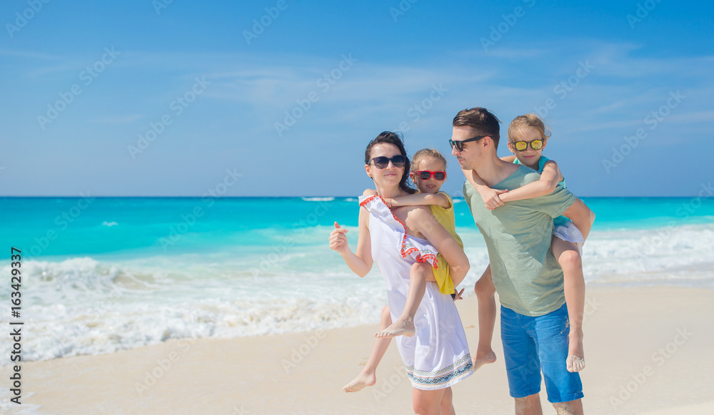 Family beach vacation. Parenta with two kids have fun on the beach Family beach vacation. Parenta with two kids have fun on the beach
