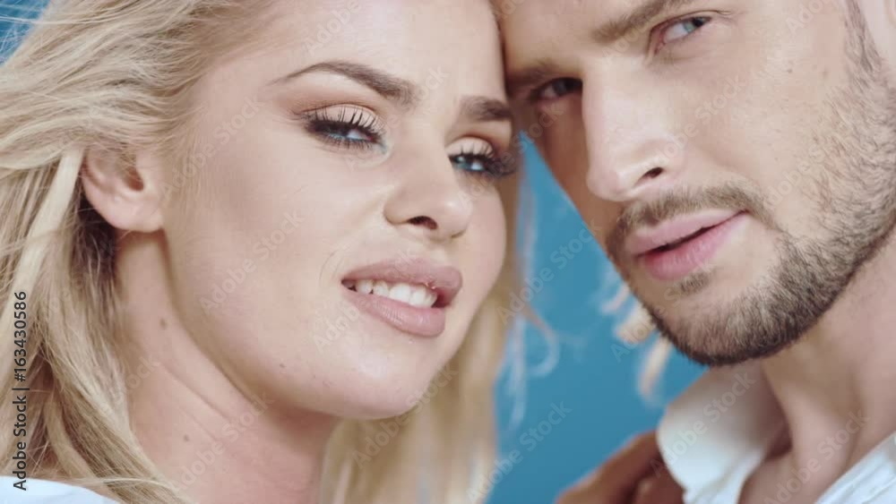 Sexy young couple posing on studio background, 4k slow motion studio clip Sexy young couple posing on studio background, 4k slow motion studio clip