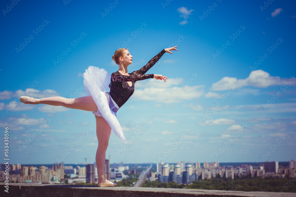 Young beautiful ballerina in city at sunny day, dancing and give a positive and inspiration for other people