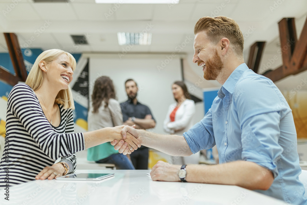 Business people shaking hands in office Business people shaking hands in office